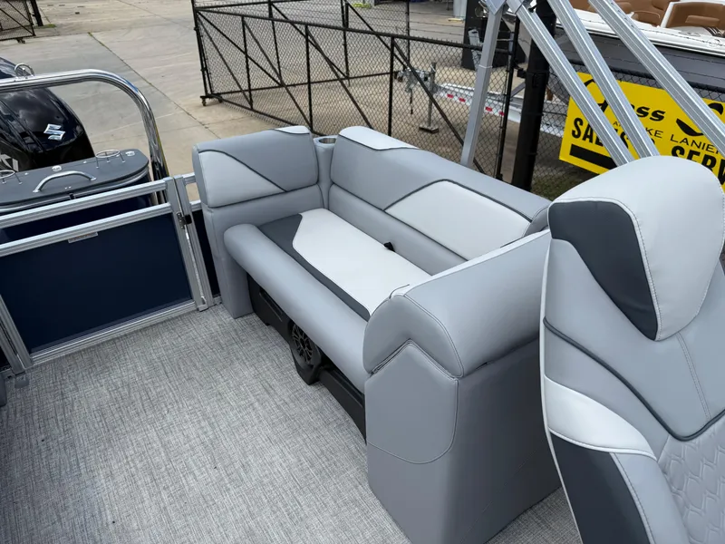 Slide: The Image of 2025 Avalon VENTURE QUAD LOUNGER boat interior with gray seating and modern design. - 19