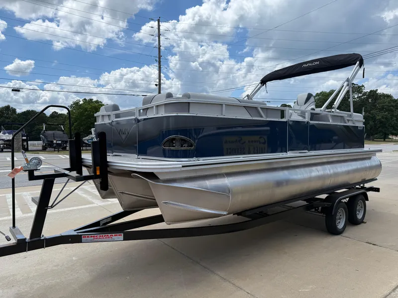 Slide: The Image of 2025 Avalon VENTURE QUAD LOUNGER pontoon boat on trailer under cloudy sky. - 3