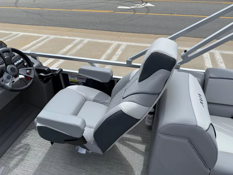 Slide: The Image of 2025 Avalon VENTURE QUAD LOUNGER boat interior with gray seating and steering console. - 36
