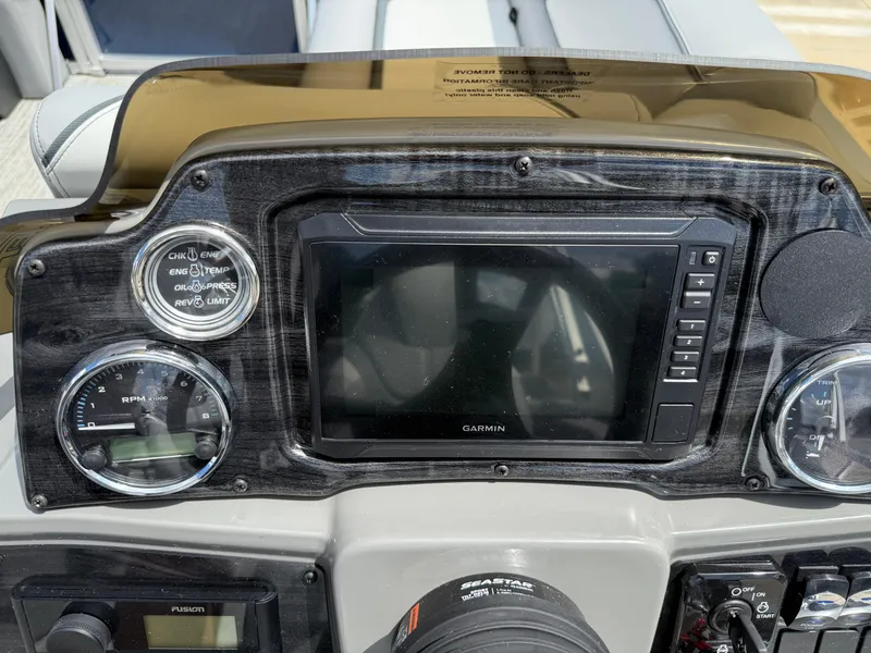 Slide: The Image of 2025 Avalon VENTURE QUAD LOUNGER dashboard with Garmin display and control gauges. - 40