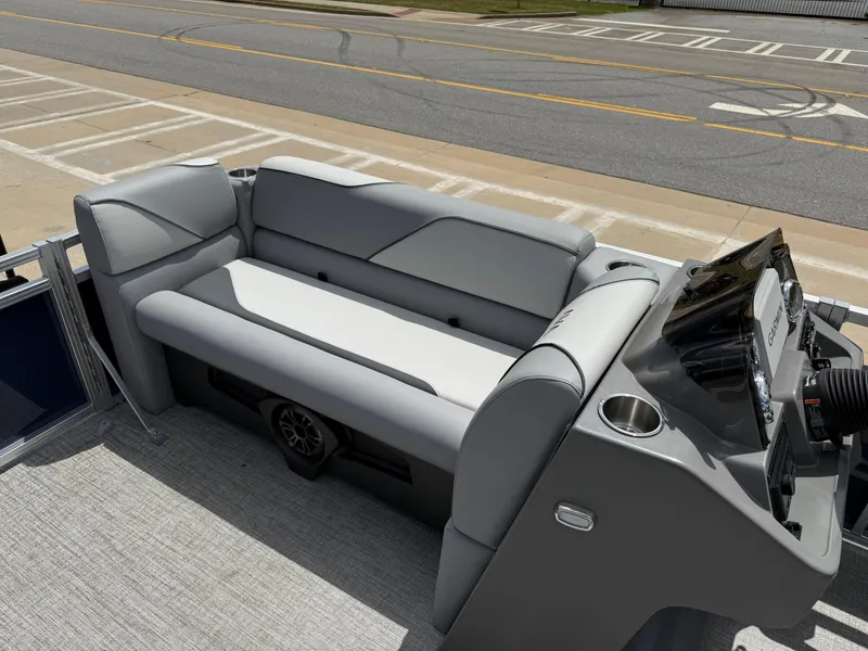 Slide: The Image of 2025 Avalon VENTURE QUAD LOUNGER boat interior with gray seating and control panel. - 41