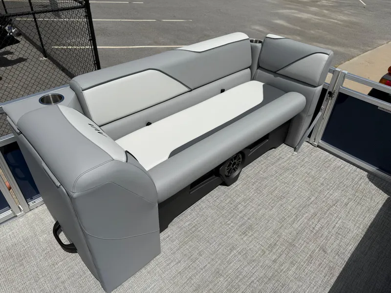 Slide: The Image of 2025 Avalon VENTURE QUAD LOUNGER boat seating, gray and white upholstery, cup holder, outdoor setting. - 42