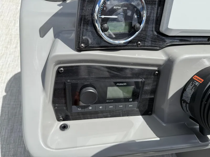 Slide: The Image of Control panel of 2025 Avalon VENTURE QUAD LOUNGER with RPM gauge and Fusion audio system. - 43