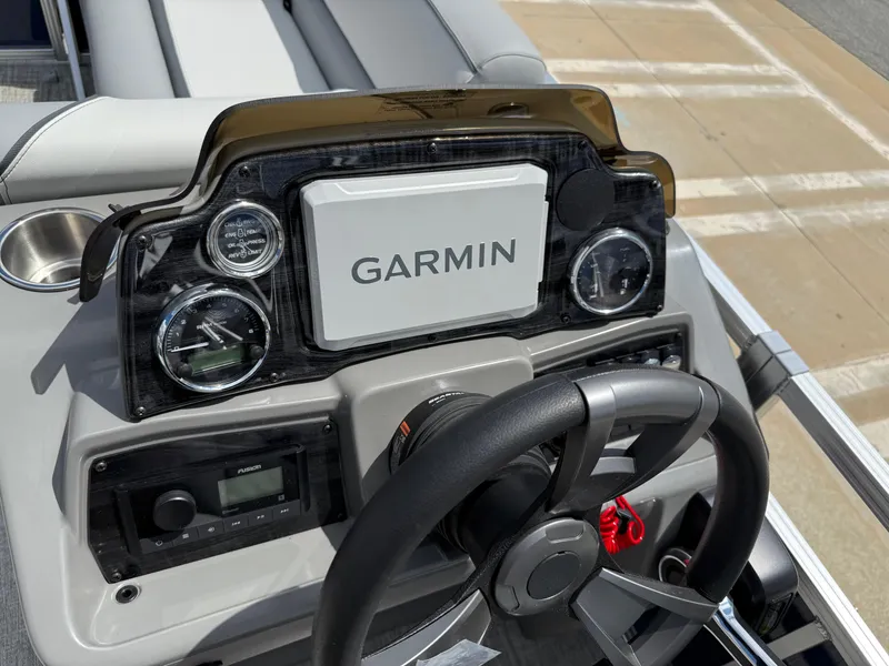 Slide: The Image of Steering console of 2025 Avalon VENTURE QUAD LOUNGER with Garmin display and gauges. - 44