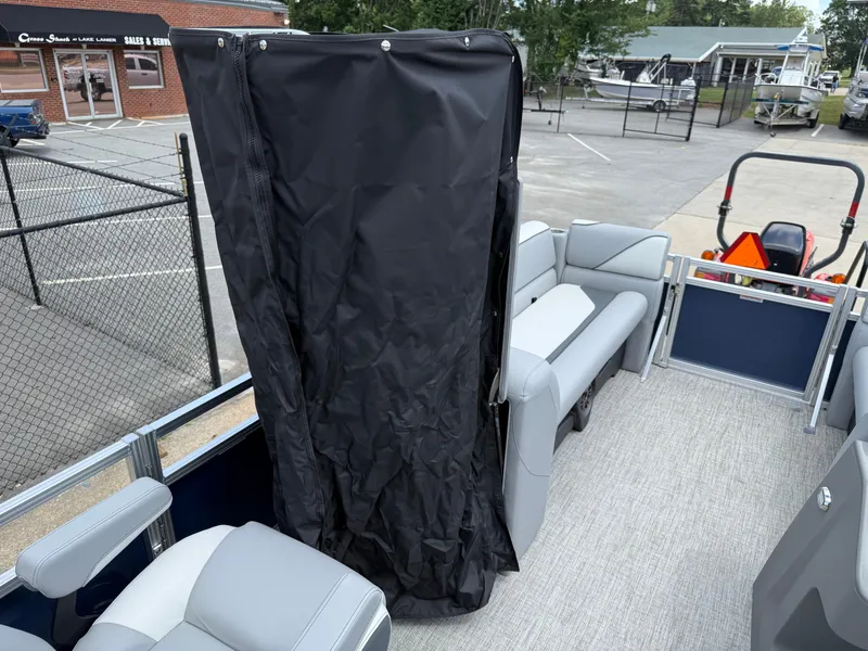 Slide: The Image of 2025 Avalon VENTURE QUAD LOUNGER boat interior with seating and privacy curtain. - 49
