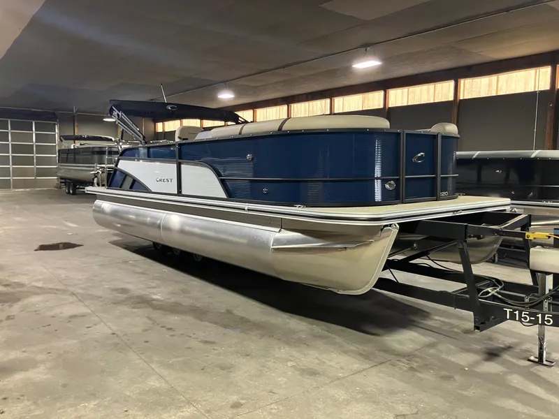 The Image of 2025 Crest 220 SLSC pontoon boat in indoor storage, featuring sleek blue design. - 0