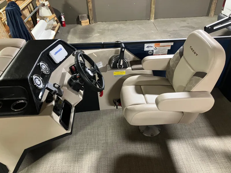 Slide: The Image of 2025 Crest 220 SLSC boat interior with steering wheel and captain's chair. - 4