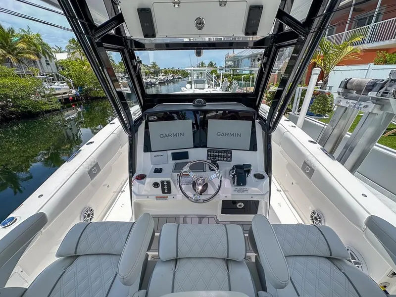 Slide: The Image of 2024 Sea Fox 328 Commander boat cockpit with Garmin displays and luxurious seating. - 15