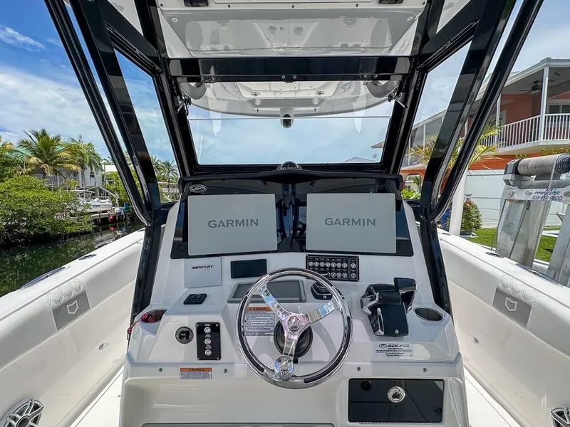 Slide: The Image of 2024 Sea Fox 328 Commander helm with dual Garmin displays and sleek steering wheel. - 16