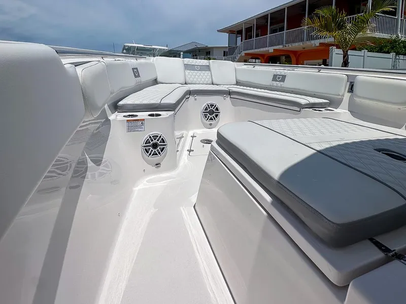 Slide: The Image of 2024 Sea Fox 328 Commander boat interior with cushioned seating and speakers. - 17