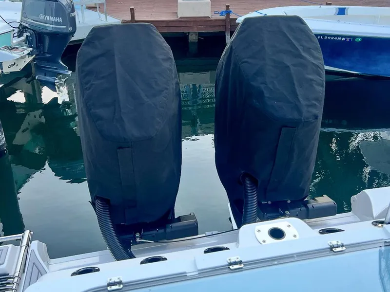 Slide: The Image of 2024 Sea Fox 328 Commander with covered outboard motors at a marina. - 24