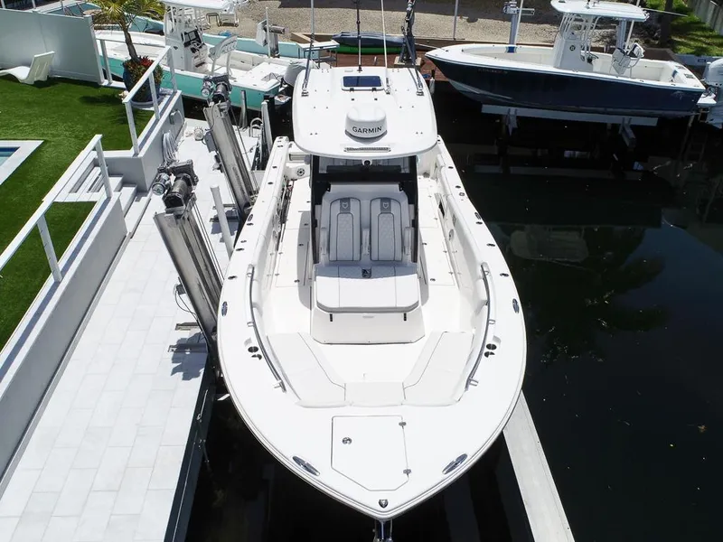 Slide: The Image of 2024 Sea Fox 328 Commander boat docked, aerial view showcasing sleek design and spacious deck. - 5