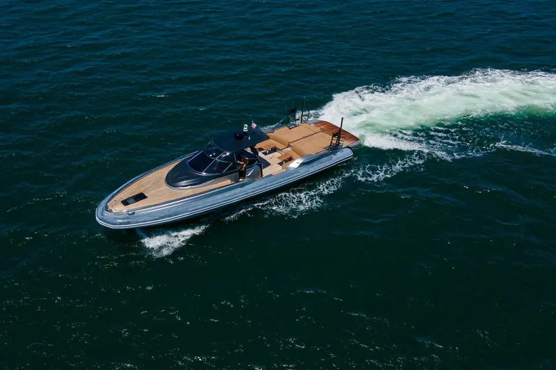 Slide: The Image of 2014 SACS Strider yacht cruising on open blue water near coastline. - 13