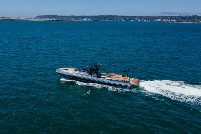 Slide: The Image of 2014 SACS Strider boat cruising on open water with comfortable seating. - 14