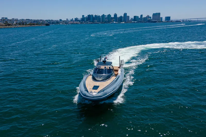 Slide: The Image of 2014 SACS Strider yacht cruising in blue waters with city skyline in background. - 3