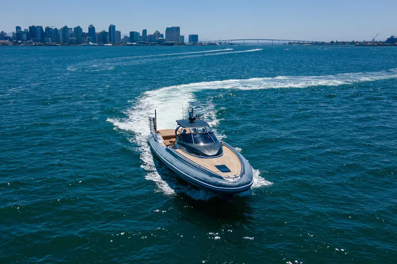 Slide: The Image of 2014 SACS Strider yacht cruising in open water with city skyline in background. - 4
