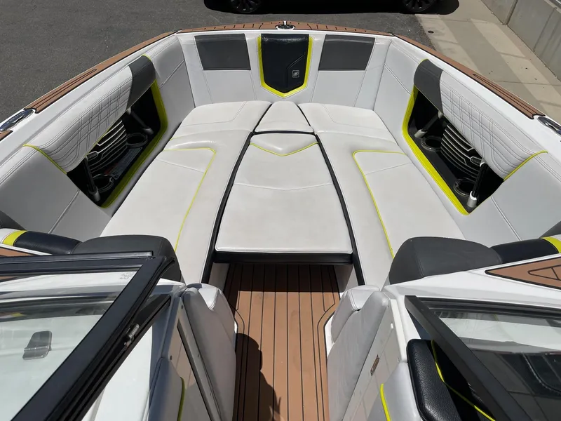 Slide: The Image of 2017 Nautique Super Air Nautique G25 boat interior with white and yellow seating. - 11