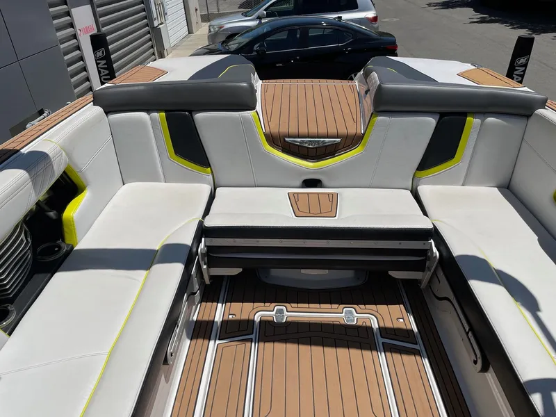 Slide: The Image of 2017 Nautique Super Air Nautique G25 boat interior with white and yellow seating. - 8