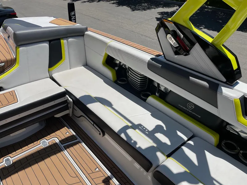 Slide: The Image of 2017 Nautique Super Air Nautique G25 interior with white and yellow seating, teak flooring. - 9