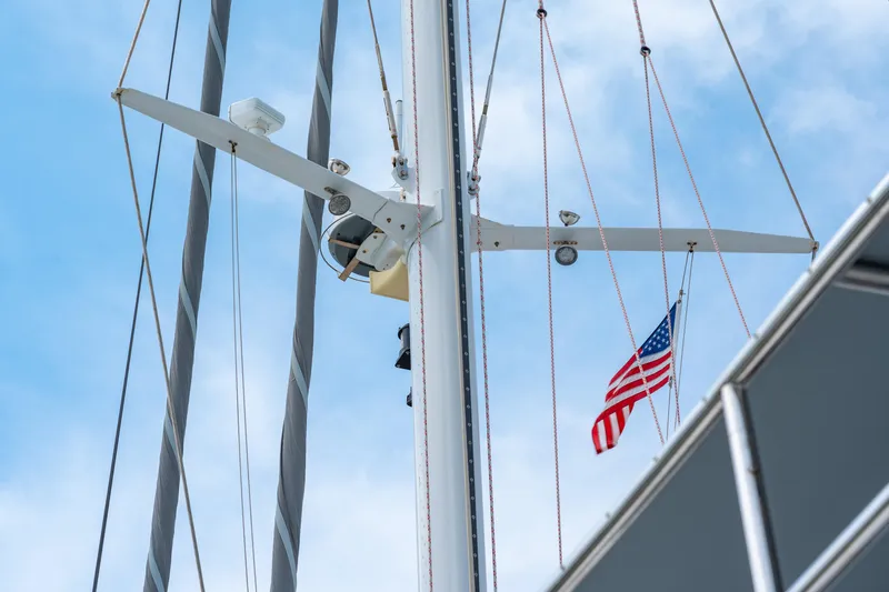 Slide: The Image of Sailboat mast with American flag, Privilege 745, 2008 model, against blue sky. - 12