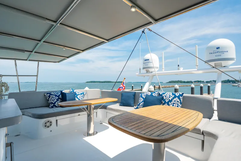 Slide: The Image of Luxurious 2008 Privilege 745 yacht deck with seating, tables, and ocean view. - 14