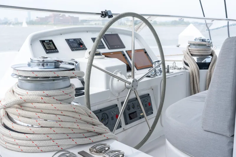 Slide: The Image of Helm of 2008 Privilege 745 yacht with navigation instruments and coiled ropes. - 23