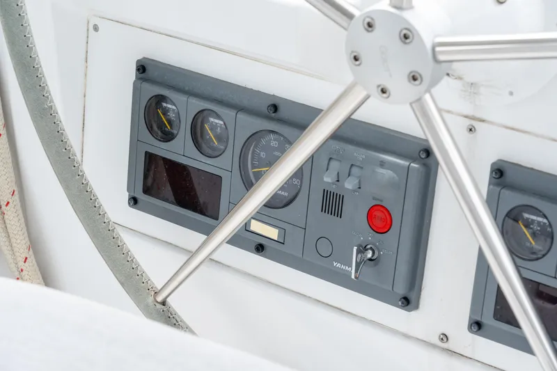 Slide: The Image of Control panel of a 2008 Privilege 745 yacht with gauges and steering wheel. - 25