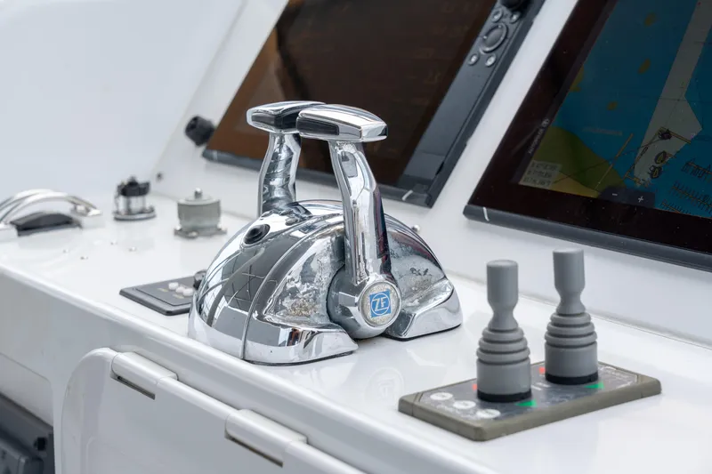 Slide: The Image of Control panel of a 2008 Privilege 745 yacht with navigation screens and throttle levers. - 26