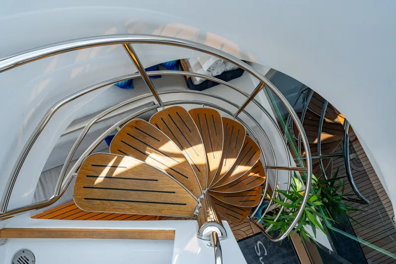 Slide: The Image of Spiral staircase on 2008 Privilege 745 yacht with wooden steps and metal railing. - 38