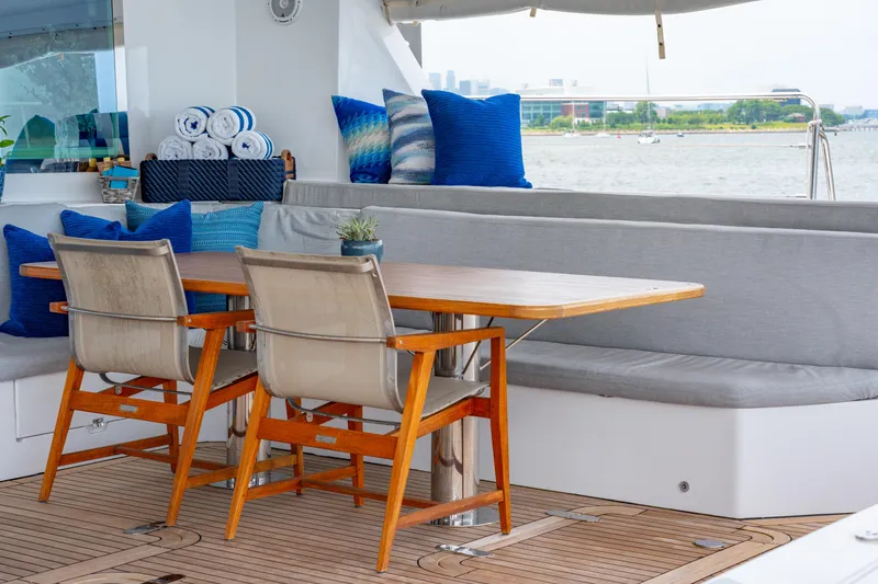 Slide: The Image of Luxury yacht deck with wooden table, chairs, and blue cushions, Privilege 745, 2008 model. - 42