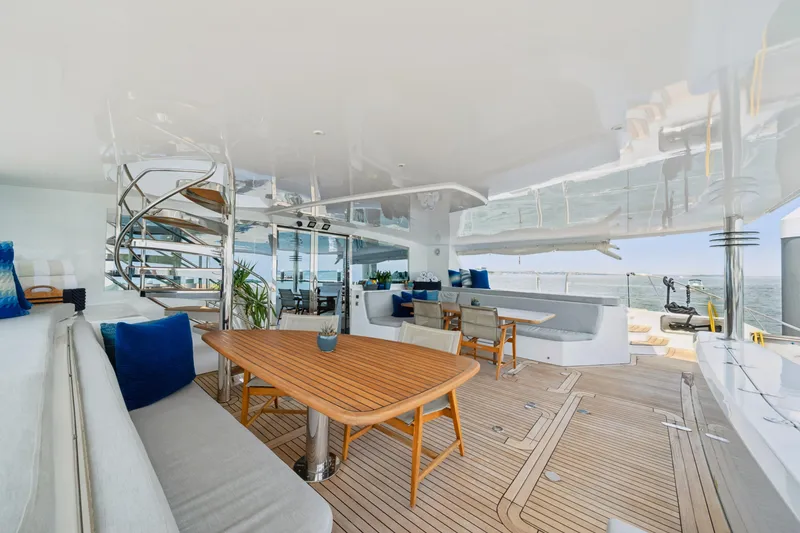 Slide: The Image of Luxurious 2008 Privilege 745 yacht deck with elegant seating and spiral staircase. - 46