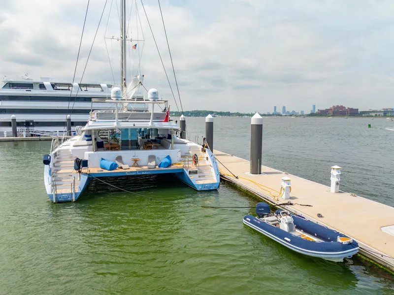 Slide: The Image of Luxury Privilege 745 yacht docked with inflatable boat, 2008 model, scenic waterfront view. - 6