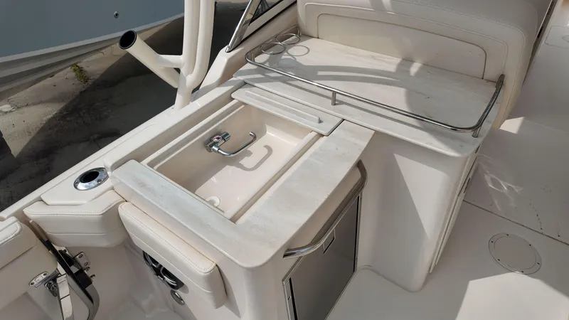Slide: The Image of 2026 Grady-White Freedom 285 boat interior with sink and storage area. - 11