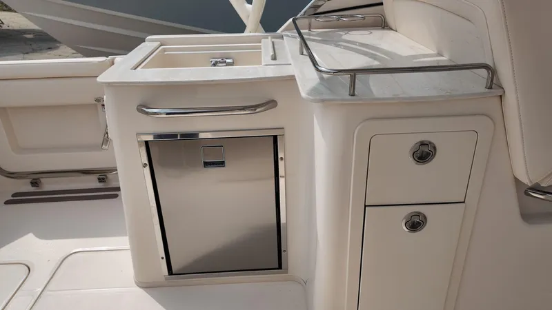 Slide: The Image of 2026 Grady-White Freedom 285 boat interior with stainless steel storage and sink. - 12