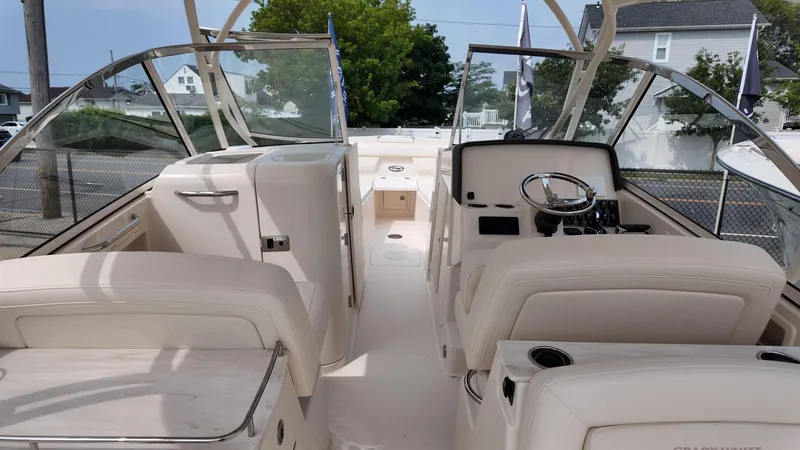 Slide: The Image of 2026 Grady-White Freedom 285 boat interior with steering wheel and seating. - 14