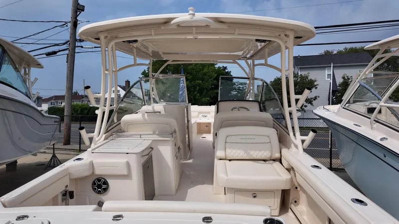 Slide: The Image of 2026 Grady-White Freedom 285 boat interior with seating and helm, docked outdoors. - 2