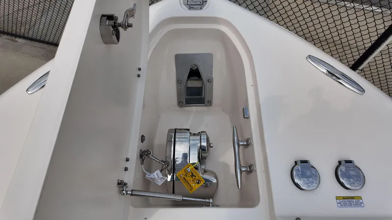 Slide: The Image of Anchor compartment of 2026 Grady-White Freedom 285 boat, featuring stainless steel fittings. - 23