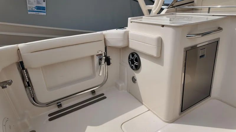 Slide: The Image of 2026 Grady-White Freedom 285 boat interior with storage and seating area. - 7