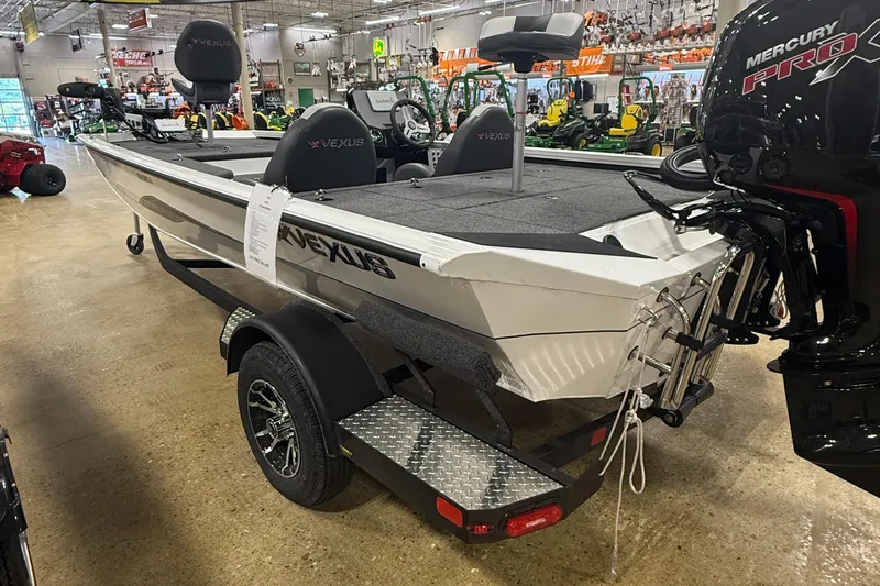 Slide: The Image of 2026 Vexus AVX189 boat displayed indoors with Mercury Pro motor and trailer. - 3