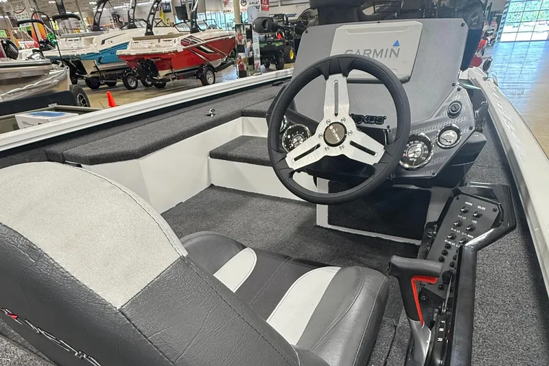 Slide: The Image of 2026 Vexus AVX189 boat interior with steering wheel and Garmin dashboard in showroom. - 6