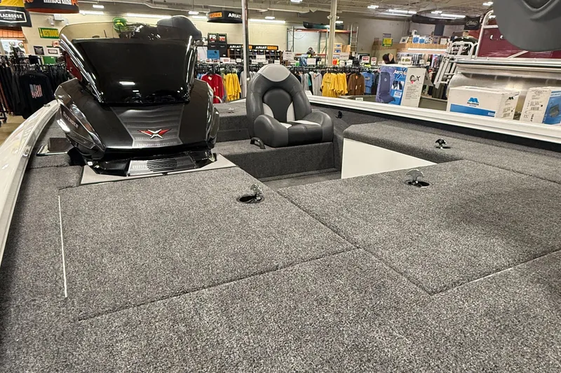 Slide: The Image of 2026 Vexus AVX189 boat interior with carpeted deck and seating in a showroom. - 7