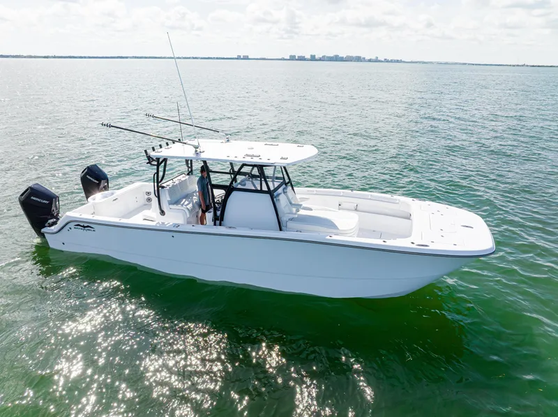 The Image of 2026 Invincible 33 Catamaran on calm water, featuring dual outboard motors. - 0