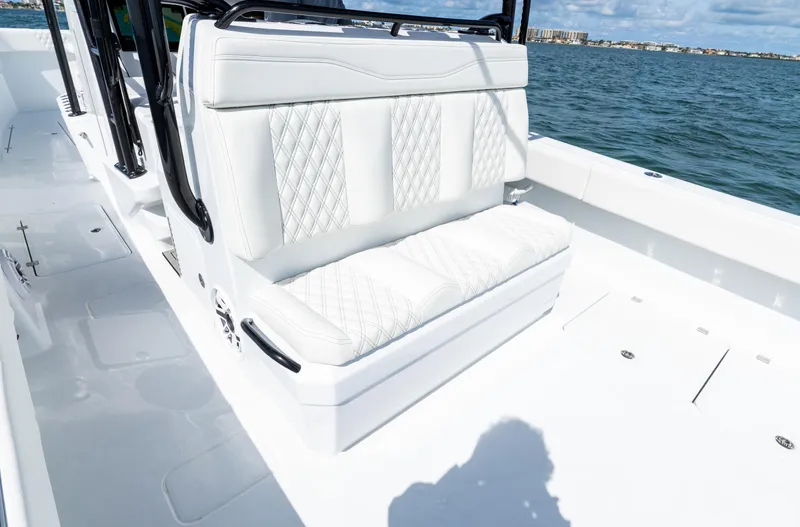 Slide: The Image of Luxurious seating on 2026 Invincible 33 Catamaran, featuring white upholstery and diamond stitching. - 12