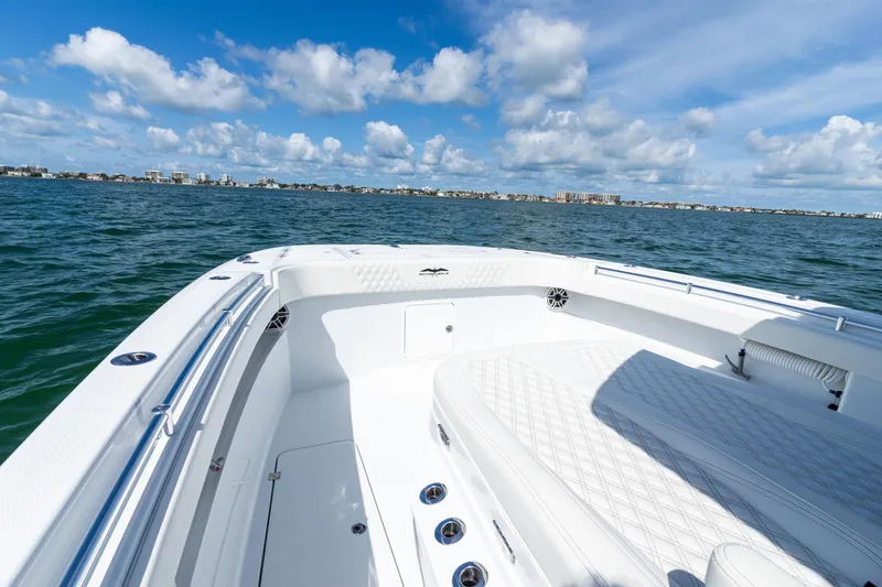 Slide: The Image of 2026 Invincible 33 Catamaran on open water, clear sky, coastal cityscape in background. - 20