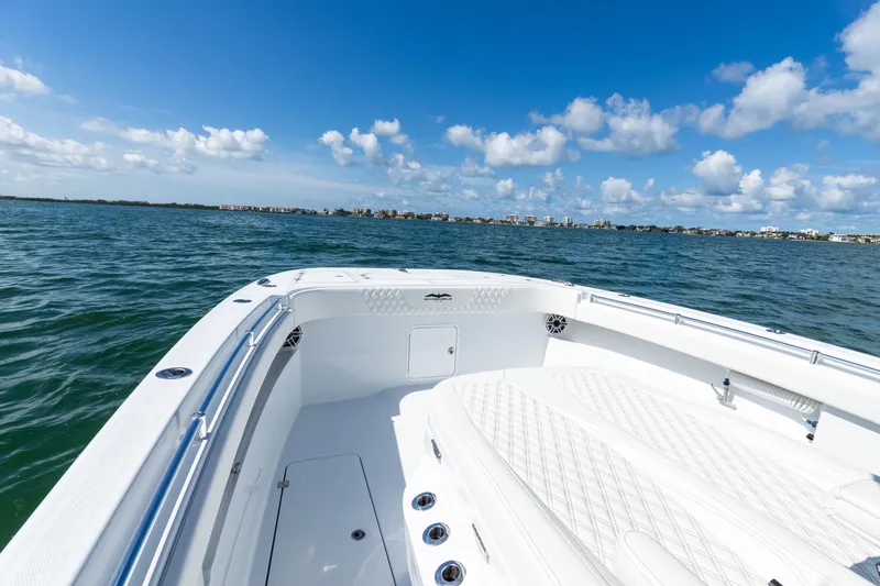 Slide: The Image of 2026 Invincible 33 Catamaran on open water under a clear blue sky. - 21