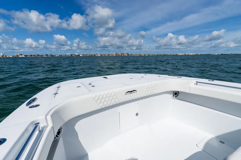 Slide: The Image of Invincible 33 Catamaran 2026 on open water under blue sky with clouds. - 23