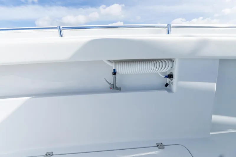 Slide: The Image of 2026 Invincible 33 Catamaran deck detail with coiled hose and fittings. - 26