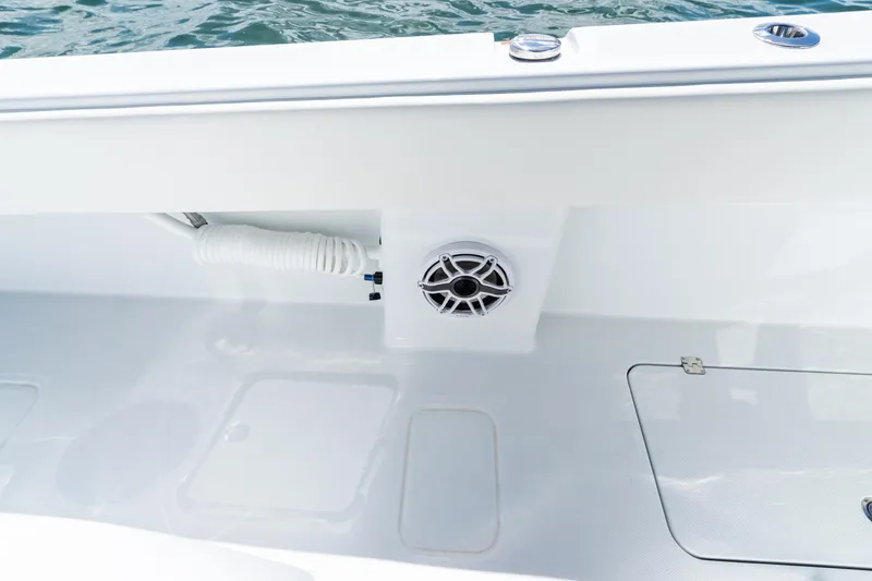 Slide: The Image of 2026 Invincible 33 Catamaran deck with speaker and coiled hose, near water. - 27