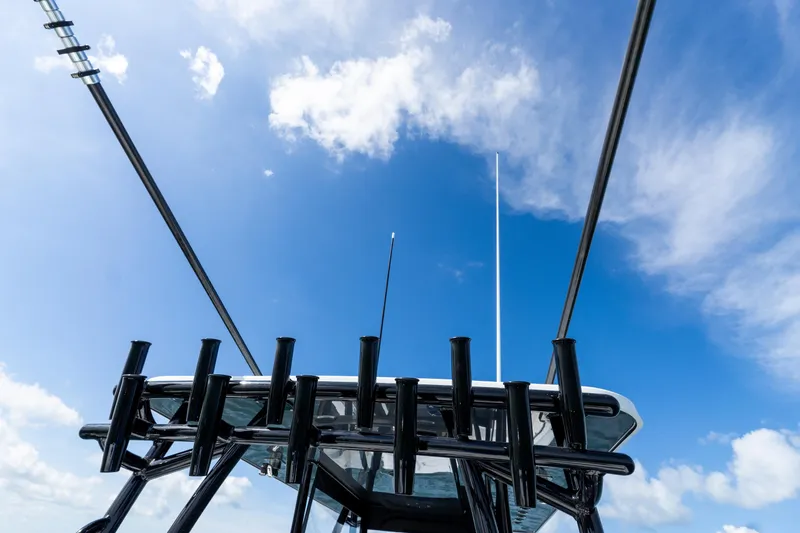 Slide: The Image of Rods and antennas on Invincible 33 Catamaran, 2026 model, against a clear blue sky. - 29