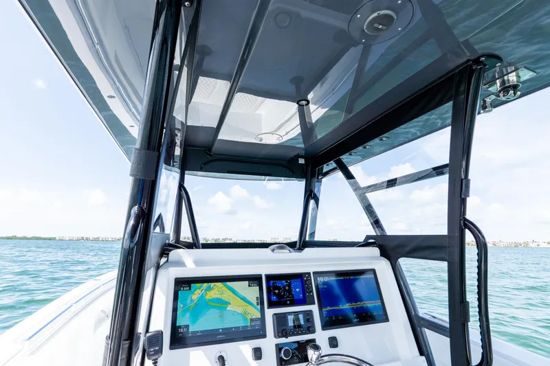 Slide: The Image of 2026 Invincible 33 Catamaran dashboard with navigation screens, on open water. - 30